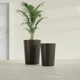 Tegel Round Tapered fiberglass planter in Matte Dark Brown, size range, in a sunlit interior