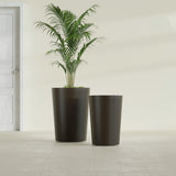 Tegel Round Tapered fiberglass planter in Matte Dark Brown, size range, in a sunlit interior