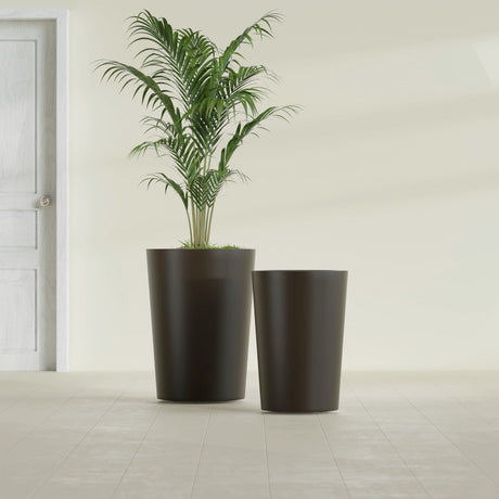 Tegel Round Tapered fiberglass planter in Matte Dark Brown, size range, in a sunlit interior