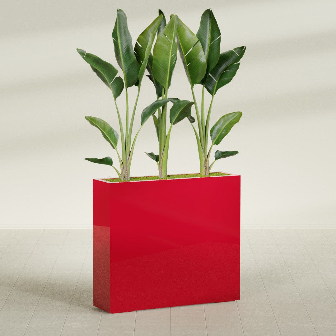 Amesbury Narrow Rectangular fiberglass planter in Gloss Red, shown planted, in a sunlit interior