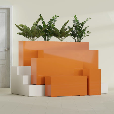 Hollywood Corner fiberglass planter in Gloss Tangerine, size range, in a sunlit interior