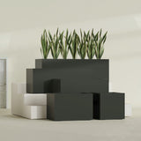 Granada fiberglass planter in Matte Charcoal, size range, in a sunlit interior