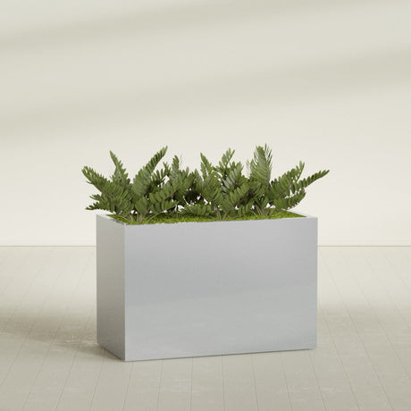 Brisbane Corner fiberglass planter in Metallic Silver, shown planted, in a sunlit interior