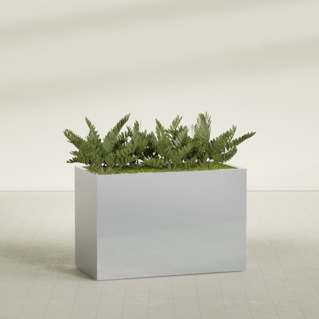 Brisbane Rectangular fiberglass planter in Metallic Silver, shown planted, in a sunlit interior