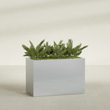 Brisbane Rectangular fiberglass planter in Metallic Silver, shown planted, in a sunlit interior