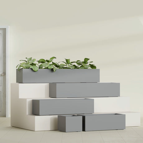 Cuba Corner fiberglass planter in Matte Gunmetal, size range, in a sunlit interior
