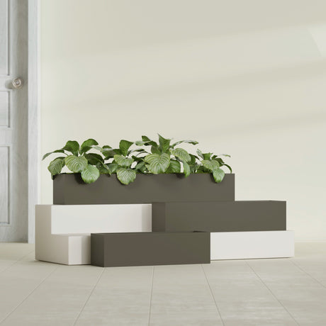 Monaco Rectangle fiberglass planter in Matte Bronze, shown planted, in a sunlit interior