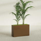 Potsdam Corner fiberglass planter in Metallic Bronze, shown planted, in a sunlit interior