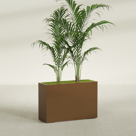 Potsdam Corner fiberglass planter in Metallic Bronze, shown planted, in a sunlit interior