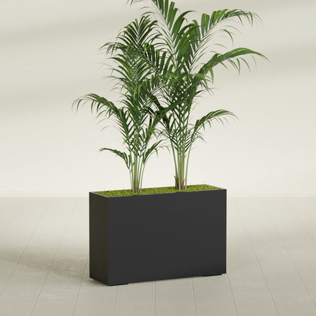 Potsdam Corner fiberglass planter in Matte Black, shown planted, in a sunlit interior