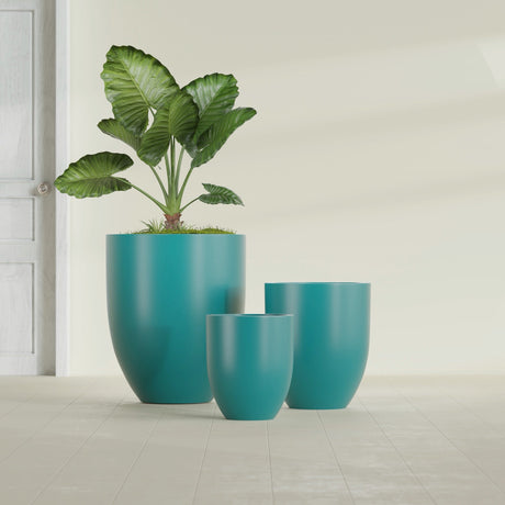 Valencia Tapered Round fiberglass planter in Satin Seafoam Green, size range, in a sunlit interior