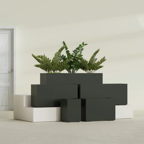 Tolga Corner fiberglass planter in Matte Charcoal, size range, in a sunlit interior