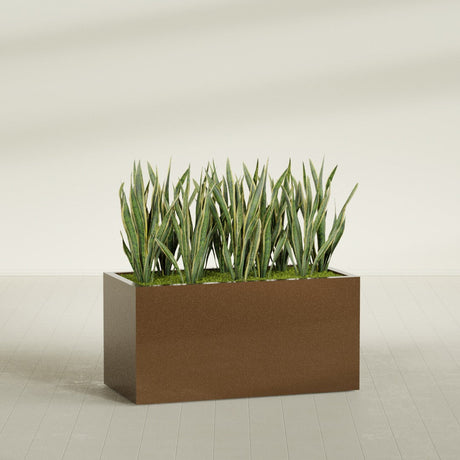 Granada fiberglass planter in Metallic Bronze, shown planted, in a sunlit interior