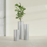 Corry Cylinder fiberglass planter in Metallic Silver, size range, in a sunlit interior