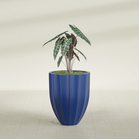 Alicante Fluted fiberglass planter in Matte Cobalt Blue, shown planted, in a sunlit interior