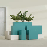 Potsdam Corner fiberglass planter in Satin Seafoam Green, size range, in a sunlit interior