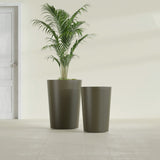 Tegel Round Tapered fiberglass planter in Matte Bronze, size range, in a sunlit interior