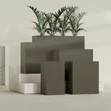 Darwin Corner fiberglass planter in Matte Bronze, size range, in a sunlit interior