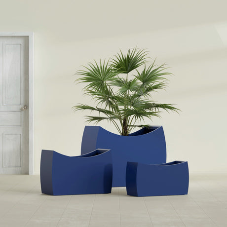 Seoul Curved fiberglass planter in Matte Cobalt Blue, size range, in a sunlit interior