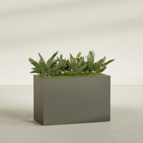 Brisbane Rectangular fiberglass planter in Matte Bronze, shown planted, in a sunlit interior