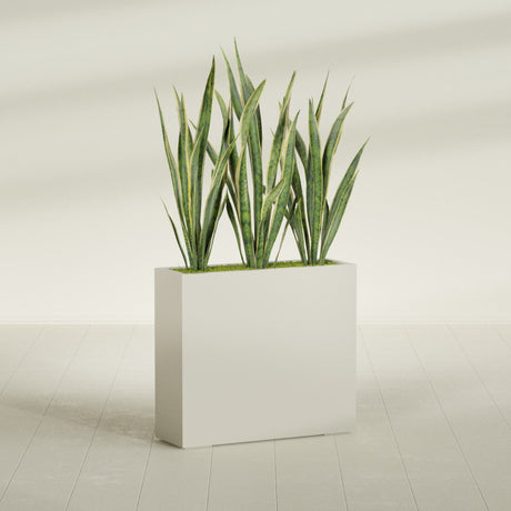 Delray Corner fiberglass planter in Satin Beige, shown planted, in a sunlit interior