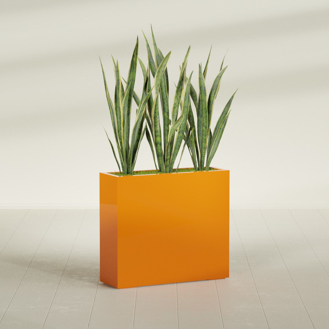 Delray Corner fiberglass planter in Gloss Tangerine, shown planted, in a sunlit interior