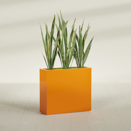 Delray Rectangular fiberglass planter in Gloss Tangerine, shown planted, in a sunlit interior