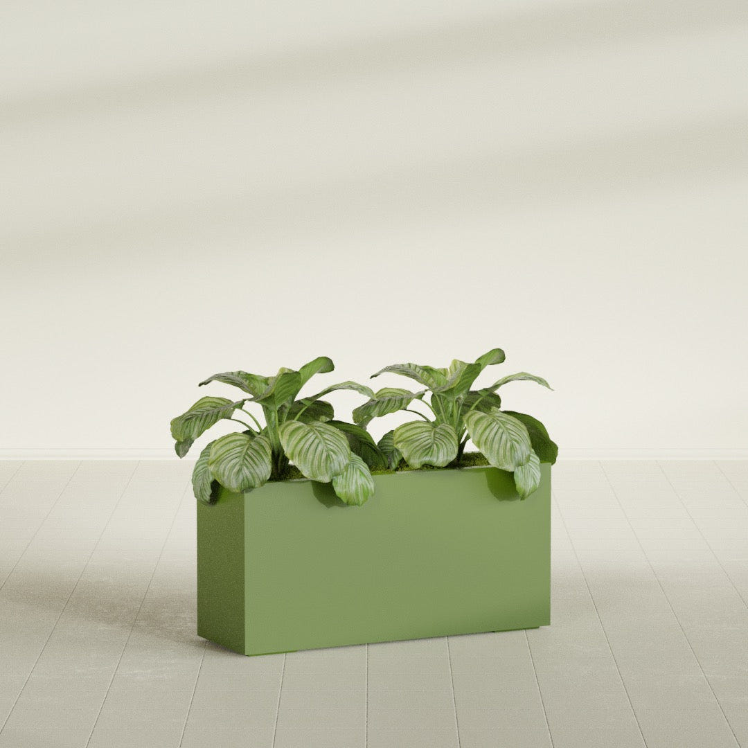 Miami Narrow Rectangular fiberglass planter in Satin Green, shown planted, in a sunlit interior