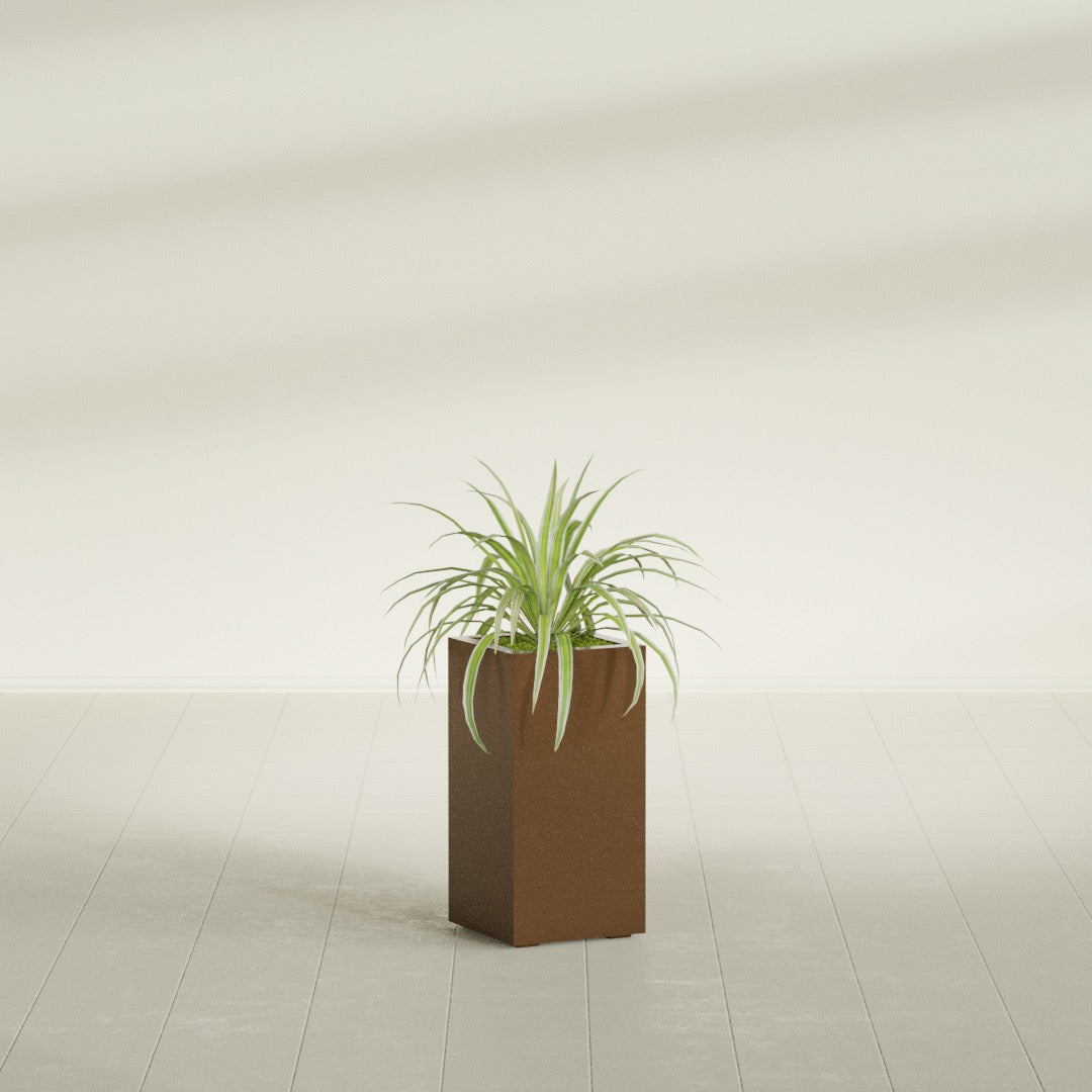 Hollywood Corner fiberglass planter in Metallic Bronze, shown planted, in a sunlit interior