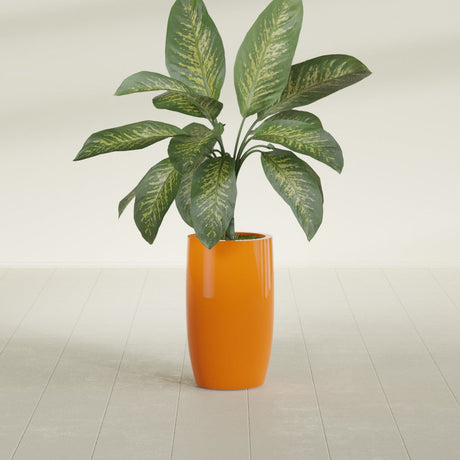 Lisbon Tall Round fiberglass planter in Gloss Tangerine, shown planted, in a sunlit interior