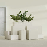 Potsdam Corner fiberglass planter in Satin Beige, size range, in a sunlit interior