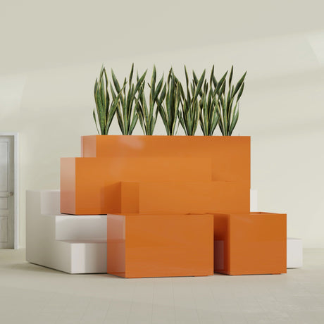 Granada fiberglass planter in Gloss Tangerine, size range, in a sunlit interior