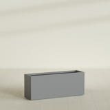 Tolga Rectangular Planter in Matte Gunmetal, 60"L × 16"D × 24"H, shown empty