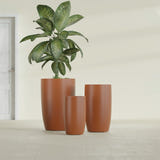Lisbon Tall Round fiberglass planter in Matte Terra Cotta, size range, in a sunlit interior