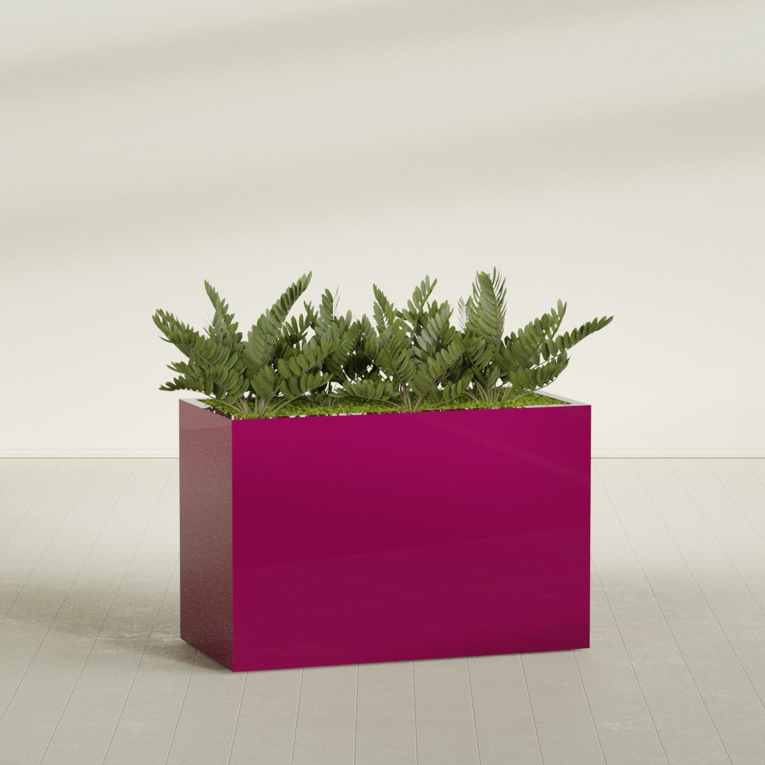 Brisbane Rectangular fiberglass planter in Gloss Eggplant, shown planted, in a sunlit interior
