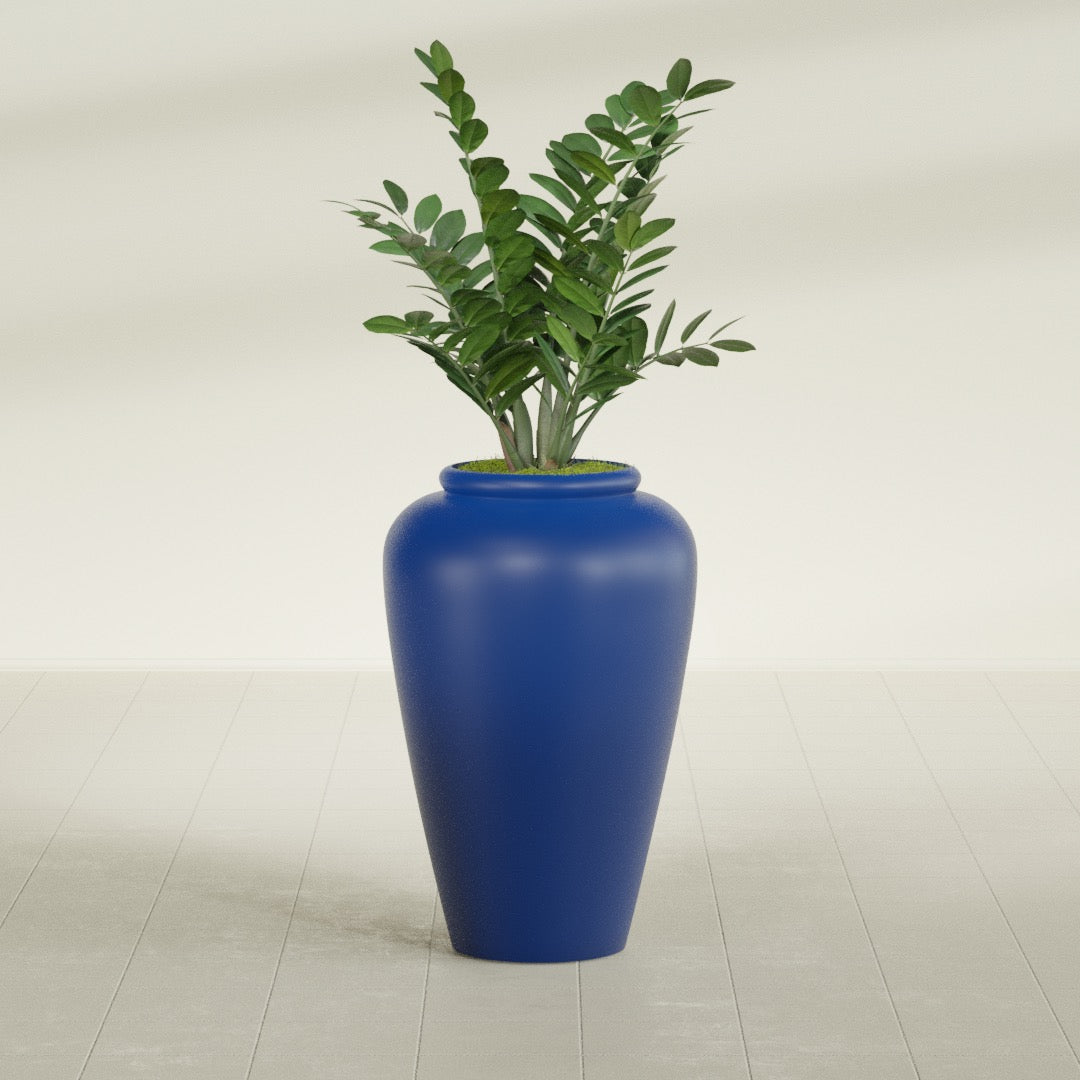 Barà Jar fiberglass planter in Matte Cobalt Blue, shown planted, in a sunlit interior