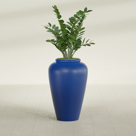 Barà Jar fiberglass planter in Matte Cobalt Blue, shown planted, in a sunlit interior