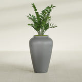 Barà Jar fiberglass planter in Matte Gunmetal, shown planted, in a sunlit interior