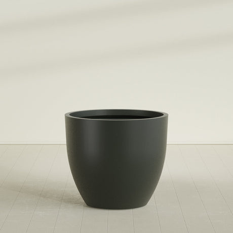 Wannsee Round Planter in Matte Charcoal, 50"D × 44"H, shown empty