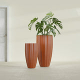 San Jose Tall Fluted fiberglass planter in Matte Terra Cotta, size range, in a sunlit interior