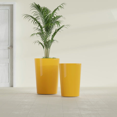 Tegel Round Tapered fiberglass planter in Gloss Saffron, size range, in a sunlit interior