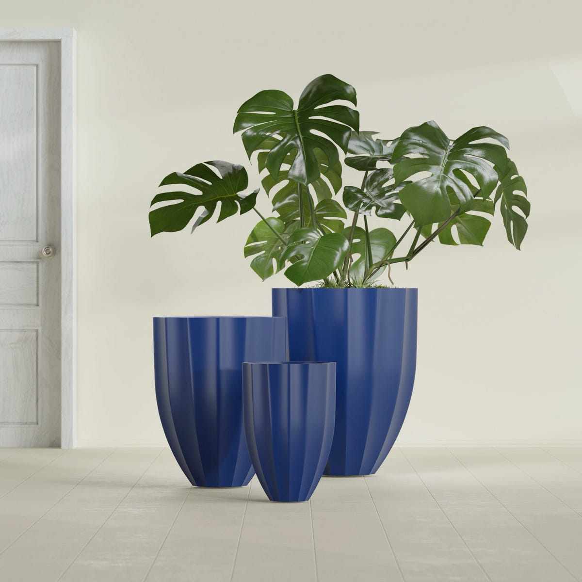 Alicante Fluted fiberglass planter in Matte Cobalt Blue, size range, in a sunlit interior