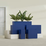 Potsdam Corner fiberglass planter in Matte Cobalt Blue, size range, in a sunlit interior