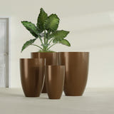 Brannan Tapered Round fiberglass planter in Metallic Bronze, size range, in a sunlit interior
