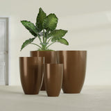 Brannan Tapered Round fiberglass planter in Metallic Bronze, size range, in a sunlit interior