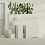 Delray Corner fiberglass planter in Satin Beige, size range, in a sunlit interior