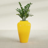 Barà Jar fiberglass planter in Gloss Saffron, shown planted, in a sunlit interior