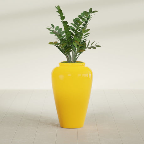 Barà Jar fiberglass planter in Gloss Saffron, shown planted, in a sunlit interior