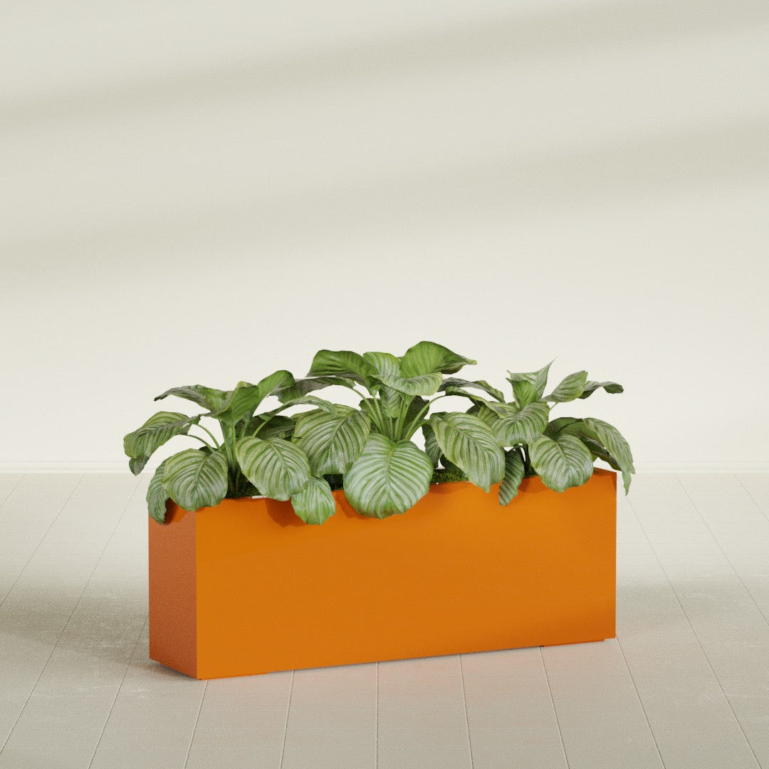 Miami Narrow fiberglass planter in Gloss Tangerine, planted, in a sunlit interior