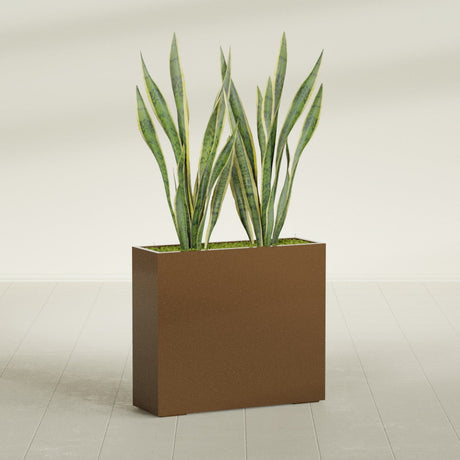 Perth Corner fiberglass planter in Metallic Bronze, shown planted, in a sunlit interior